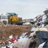 Bulldozer clearing rubbish at a landfill