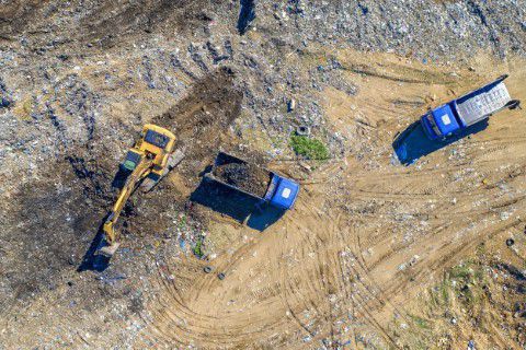 Drone shot of machinery clearing a landfill