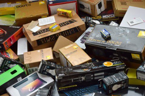 Electronic equipment in boxes ready to be trashed